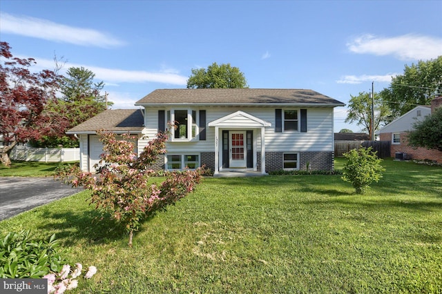 1507 Hemlock Ave, Carlisle, PA 17013 - bi-level home with an attached garage, driveway, and cooling unit