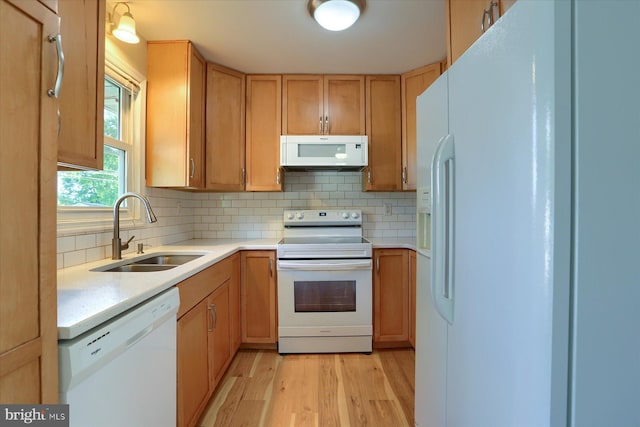 1507 Hemlock Ave, Carlisle, PA 17013 - kitchen with white appliances, a sink, light countertops, light wood-type flooring, and decorative backsplash
