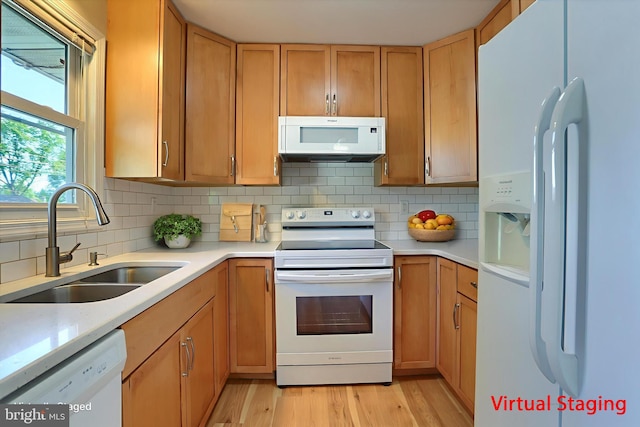 1507 Hemlock Ave, Carlisle, PA 17013 - kitchen with white appliances, a sink, light countertops, light wood-style floors, and decorative backsplash