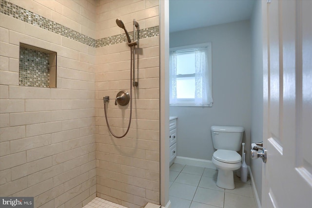 1507 Hemlock Ave, Carlisle, PA 17013 - bathroom featuring a tile shower, toilet, tile patterned flooring, and baseboards