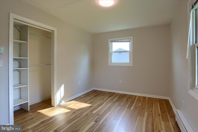 1507 Hemlock Ave, Carlisle, PA 17013 - unfurnished bedroom with a baseboard heating unit, wood-type flooring, baseboards, and a closet