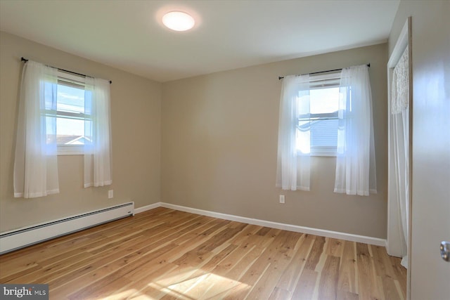 1507 Hemlock Ave, Carlisle, PA 17013 - unfurnished room featuring a baseboard radiator, light wood finished floors, healthy amount of natural light, and baseboards