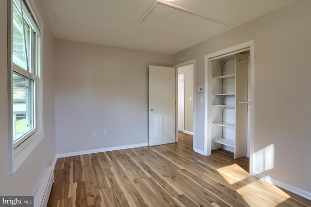 1507 Hemlock Ave, Carlisle, PA 17013 - unfurnished bedroom featuring attic access, multiple windows, light wood finished floors, and baseboards
