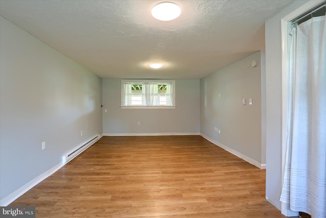 1507 Hemlock Ave, Carlisle, PA 17013 - unfurnished room featuring baseboard heating, a textured ceiling, light wood-style flooring, and baseboards