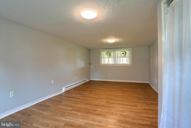 1507 Hemlock Ave, Carlisle, PA 17013 - empty room with a baseboard radiator, light wood finished floors, baseboards, and a textured ceiling