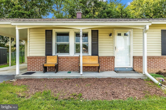10801 Oak Valley Dr, Hagerstown, MD 21740 - entrance to property featuring brick siding, covered porch, a chimney, and an attached carport