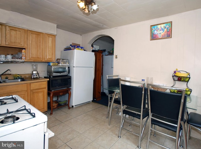 33 Adeline St, Trenton, NJ 08611 - kitchen with white appliances, a sink, and arched walkways