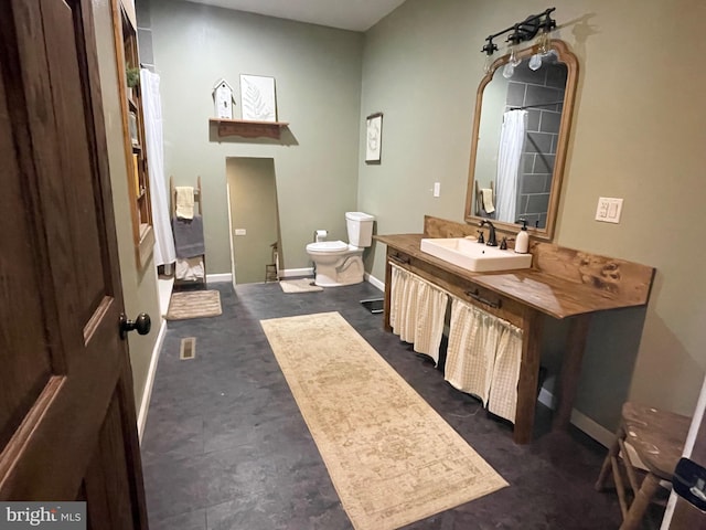 4306 National Pike, Markleysburg, PA 15459 - bathroom featuring toilet, vanity, and baseboards