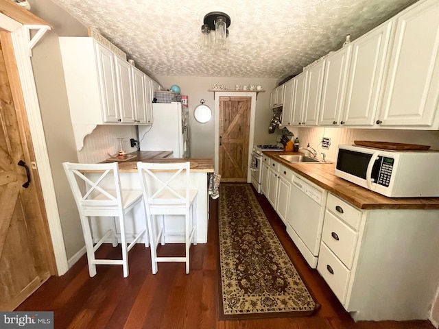 4306 National Pike, Markleysburg, PA 15459 - kitchen with white appliances, a sink, butcher block counters, dark wood-style flooring, and a peninsula