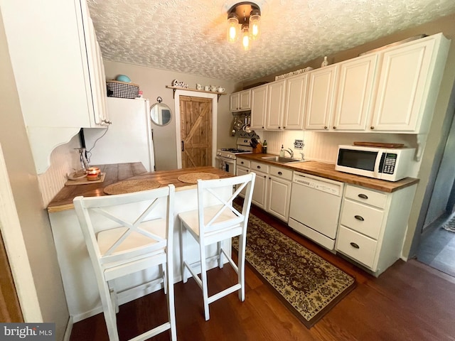 4306 National Pike, Markleysburg, PA 15459 - kitchen featuring white appliances, a sink, butcher block countertops, a textured ceiling, and dark wood finished floors