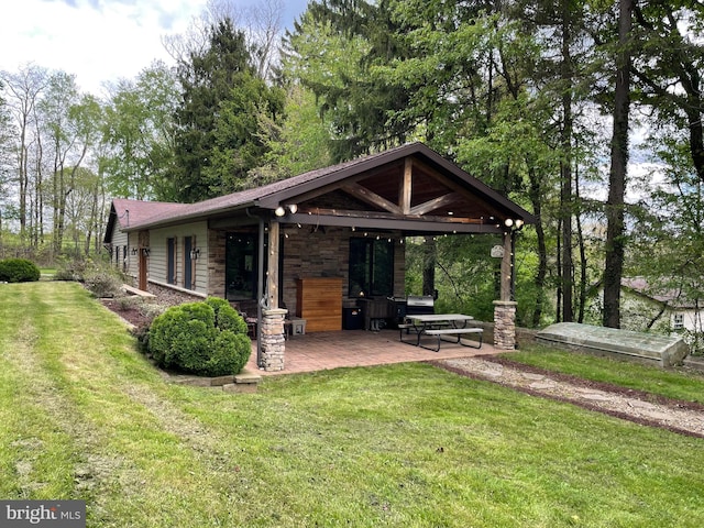 4306 National Pike, Markleysburg, PA 15459 - rear view of property with stone siding, a patio area, and a lawn
