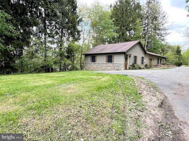 4306 National Pike, Markleysburg, PA 15459 - view of home's exterior featuring stone siding, asphalt driveway, and a lawn