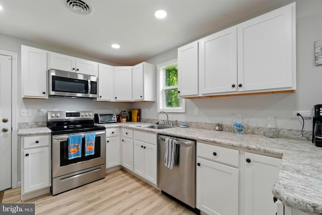 21363 Indiana Ave, Chestertown, MD 21620 - kitchen featuring stainless steel appliances, a sink, white cabinetry, light wood-type flooring, and recessed lighting