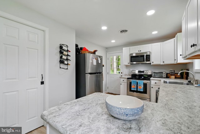 21363 Indiana Ave, Chestertown, MD 21620 - kitchen featuring stainless steel appliances, a sink, white cabinetry, recessed lighting, and a peninsula