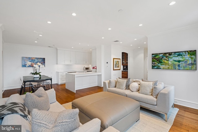 1901 Walnut St Unit 20E, Philadelphia, PA 19103 - living room with ornamental molding, recessed lighting, wood finished floors, arched walkways, and baseboards