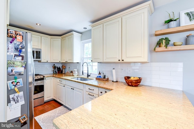 3819 14th St S, Arlington, VA 22204 - kitchen with stainless steel appliances, a sink, open shelves, tasteful backsplash, and wood finished floors