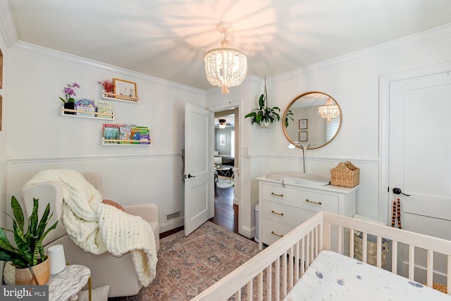 3819 14th St S, Arlington, VA 22204 - bedroom with a chandelier, crown molding, a crib, and wood finished floors