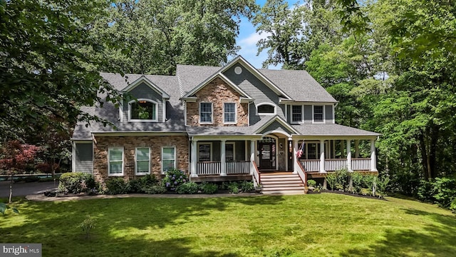 4510 Fish Hawk Ct, Chesapeake Beach, MD 20732 - view of front facade with stone siding, a porch, a front yard, and a shingled roof