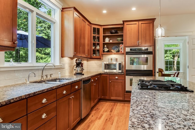 4510 Fish Hawk Ct, Chesapeake Beach, MD 20732 - kitchen with appliances with stainless steel finishes, light stone countertops, brown cabinets, and recessed lighting