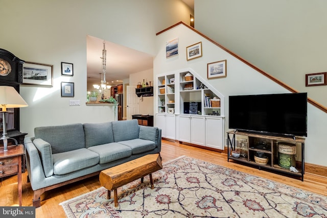 4510 Fish Hawk Ct, Chesapeake Beach, MD 20732 - living area with a chandelier, wood finished floors, and a high ceiling