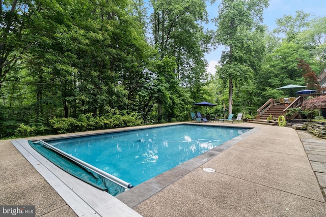 4510 Fish Hawk Ct, Chesapeake Beach, MD 20732 - view of pool featuring stairs, a covered pool, a patio area, and a deck
