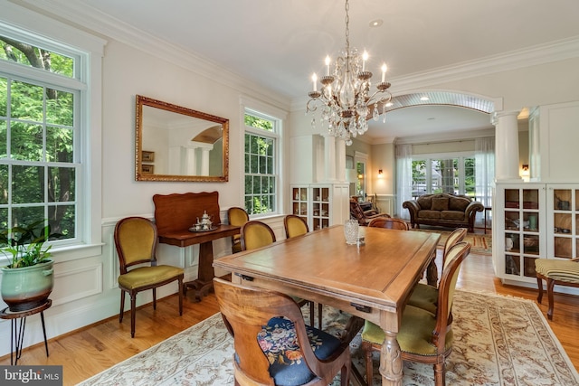 4510 Fish Hawk Ct, Chesapeake Beach, MD 20732 - dining space with light wood finished floors, a chandelier, crown molding, a wainscoted wall, and a decorative wall