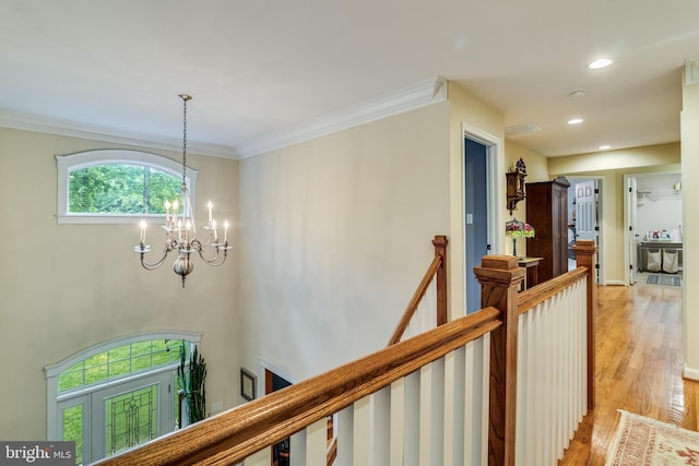 4510 Fish Hawk Ct, Chesapeake Beach, MD 20732 - corridor featuring light wood-type flooring, an upstairs landing, a chandelier, recessed lighting, and ornamental molding