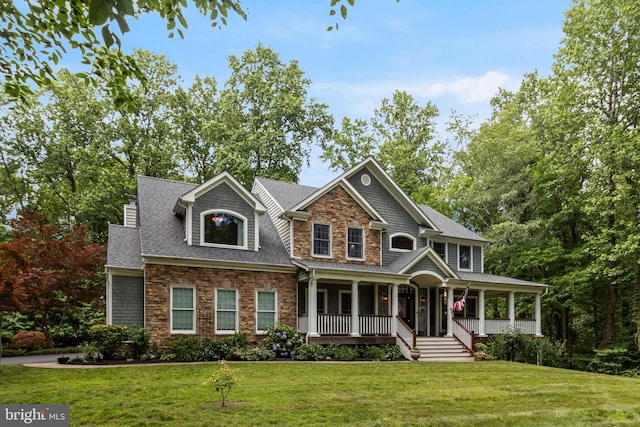 4510 Fish Hawk Ct, Chesapeake Beach, MD 20732 - view of front of house with stone siding, a porch, a front yard, and a shingled roof