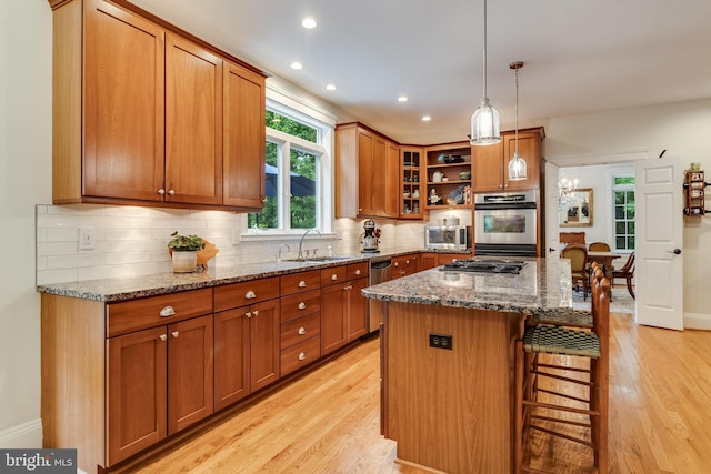 4510 Fish Hawk Ct, Chesapeake Beach, MD 20732 - kitchen featuring appliances with stainless steel finishes, light wood-type flooring, brown cabinetry, a breakfast bar, and recessed lighting