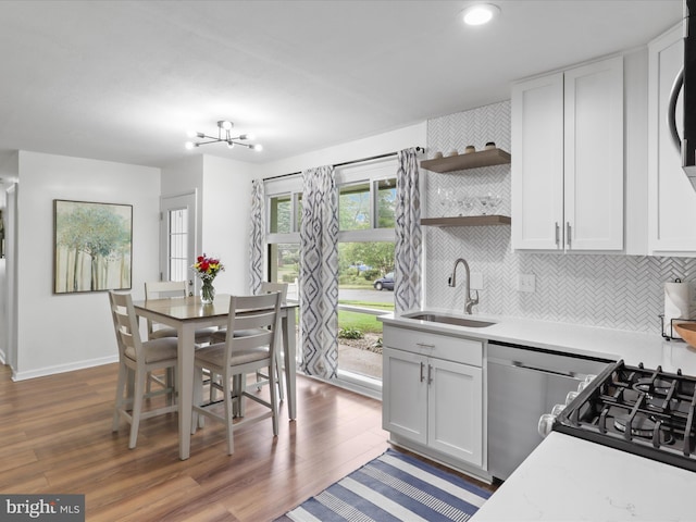 5902 Amelia St, Springfield, VA 22150 - kitchen featuring a sink, dishwasher, dark wood-style flooring, light countertops, and recessed lighting