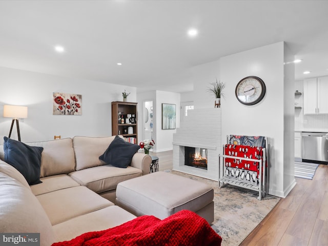 5902 Amelia St, Springfield, VA 22150 - living room featuring recessed lighting, light wood finished floors, a brick fireplace, and baseboards