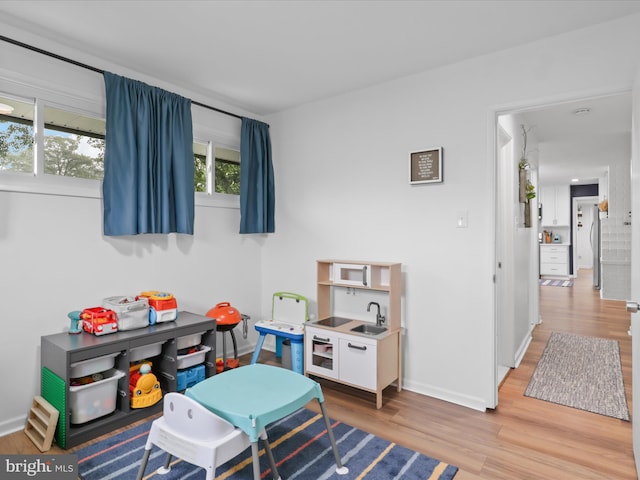 5902 Amelia St, Springfield, VA 22150 - rec room featuring light wood-type flooring, baseboards, and a sink