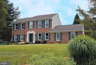 1191 Lafayette Dr, Eldersburg, MD 21784 - colonial-style house with a front yard and brick siding