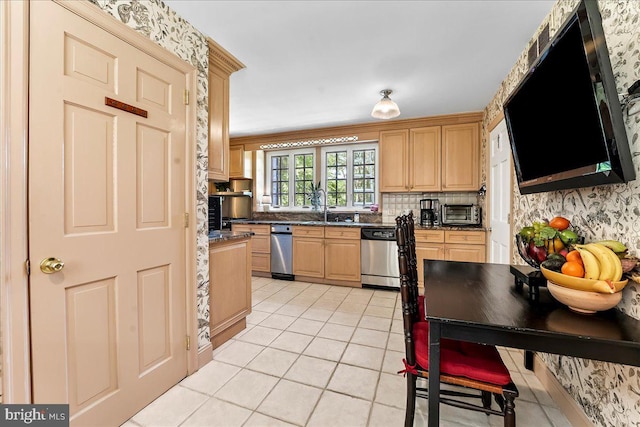 716 Old Gulph Rd, Bryn Mawr, PA 19010 - kitchen featuring stainless steel dishwasher, light tile patterned floors, a sink, dark countertops, and backsplash