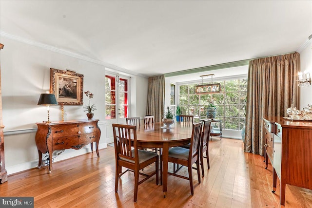 716 Old Gulph Rd, Bryn Mawr, PA 19010 - dining area featuring crown molding, light wood-style flooring, and a chandelier