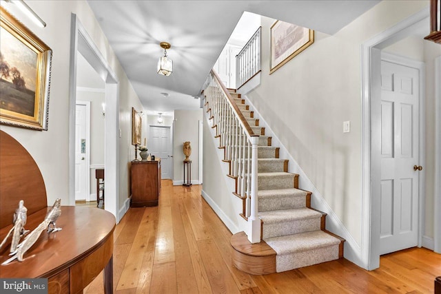 716 Old Gulph Rd, Bryn Mawr, PA 19010 - entryway with light wood-style flooring, stairway, and baseboards
