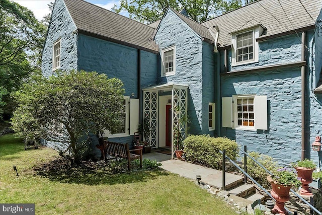 716 Old Gulph Rd, Bryn Mawr, PA 19010 - back of house featuring stucco siding, a lawn, stone siding, and a high end roof