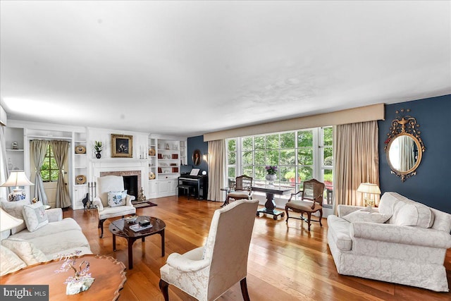 716 Old Gulph Rd, Bryn Mawr, PA 19010 - living area featuring wood finished floors, a fireplace, and built in shelves