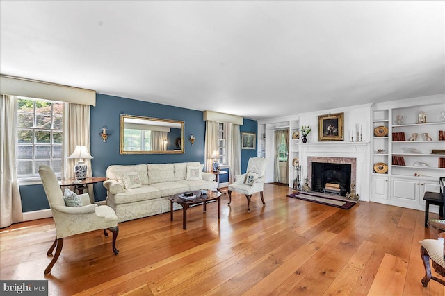 716 Old Gulph Rd, Bryn Mawr, PA 19010 - living area featuring a fireplace with raised hearth and light wood finished floors