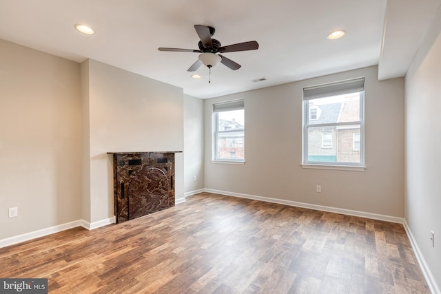 1011 Stiles St, Baltimore, MD 21202 - unfurnished living room featuring wood finished floors, a fireplace, baseboards, ceiling fan, and recessed lighting