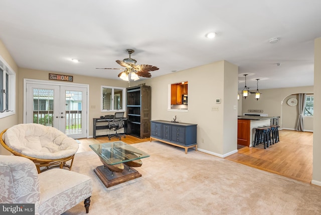1157 Pine Tree Dr, Annapolis, MD 21409 - living room featuring french doors, light wood-type flooring, a ceiling fan, and a desk