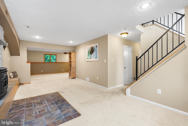 1157 Pine Tree Dr, Annapolis, MD 21409 - unfurnished living room featuring carpet flooring, a wood stove, a textured ceiling, stairway, and recessed lighting