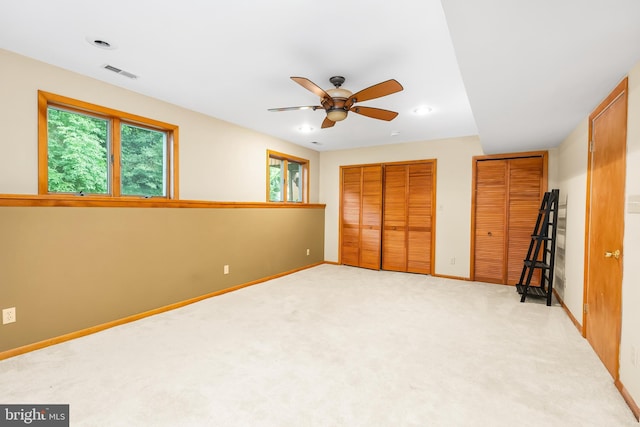 1157 Pine Tree Dr, Annapolis, MD 21409 - unfurnished bedroom featuring multiple windows, recessed lighting, carpet floors, two closets, and a ceiling fan