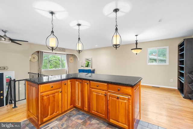 1157 Pine Tree Dr, Annapolis, MD 21409 - kitchen featuring ceiling fan, brown cabinetry, and decorative light fixtures