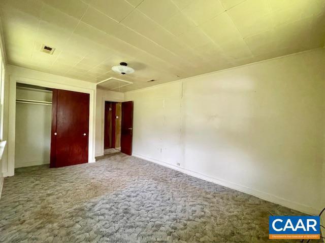 24 E 1st St, Craigsville, VA 24430 - unfurnished bedroom featuring carpet flooring, baseboards, attic access, and a closet