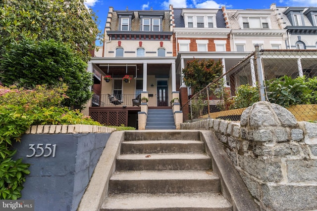 3551 13th St NW, Washington, DC 20010 - townhome / multi-family property featuring mansard roof, stairway, and covered porch