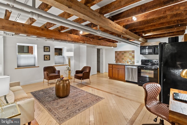 3551 13th St NW, Washington, DC 20010 - living area featuring light wood-style flooring and baseboards