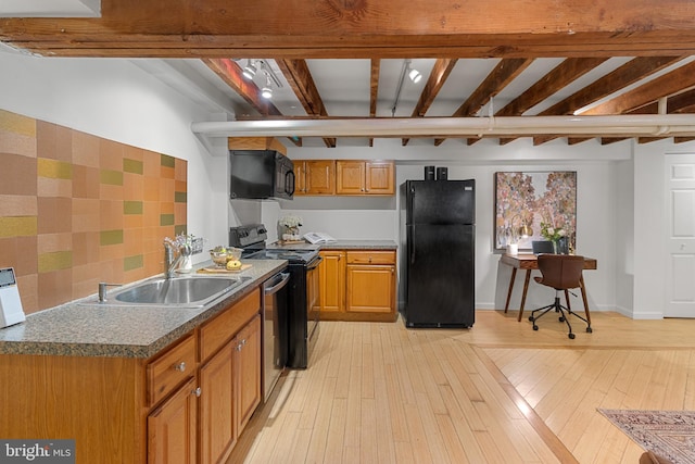 3551 13th St NW, Washington, DC 20010 - kitchen featuring black appliances, a sink, light wood-style flooring, brown cabinetry, and dark countertops