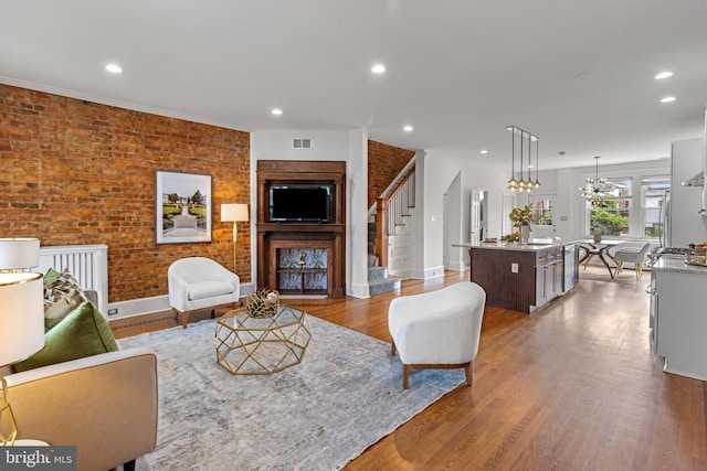 3551 13th St NW, Washington, DC 20010 - living room with stairs, wood finished floors, recessed lighting, baseboards, and a chandelier