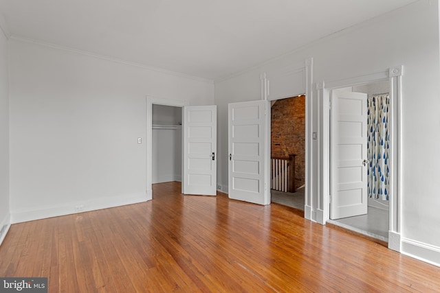 3551 13th St NW, Washington, DC 20010 - unfurnished bedroom with hardwood / wood-style floors, baseboards, a closet, and crown molding